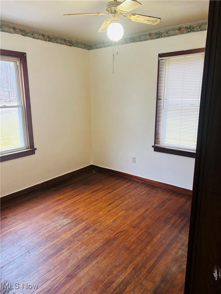 685 Furnace Road Conneaut, OH 44030 - Photo 16 of 22 Bedroom room featuring ceiling fan, dark wood finished floors, and baseboards