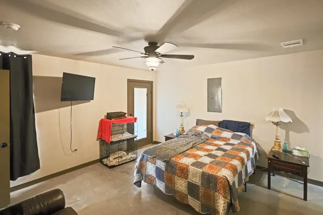 a bedroom with a bed and ceiling fan
