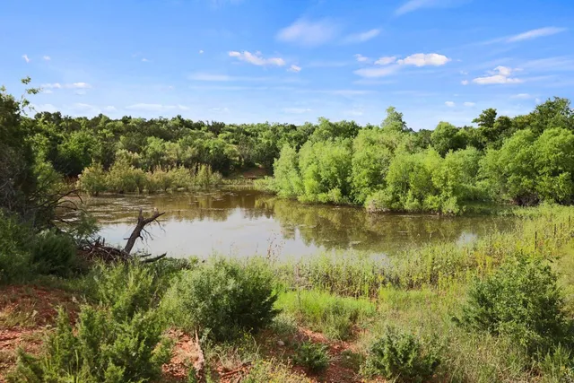 a view of a lake with houses in the back