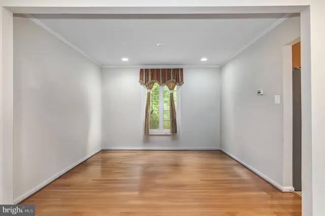 a view of room with window and wooden floor