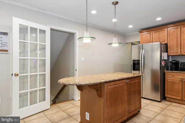 a kitchen with stainless steel appliances granite countertop a refrigerator and a sink