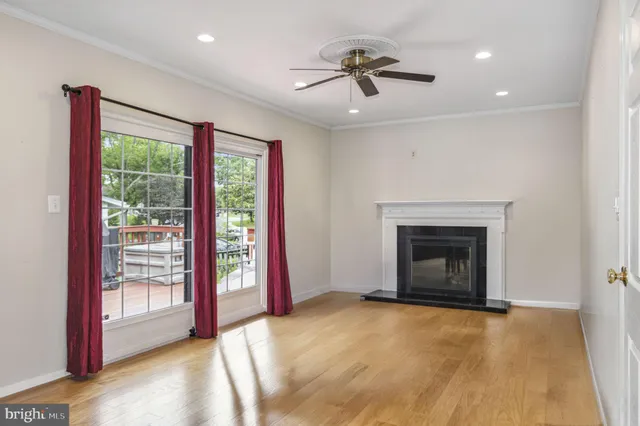 a view of an empty room with a fireplace and a window