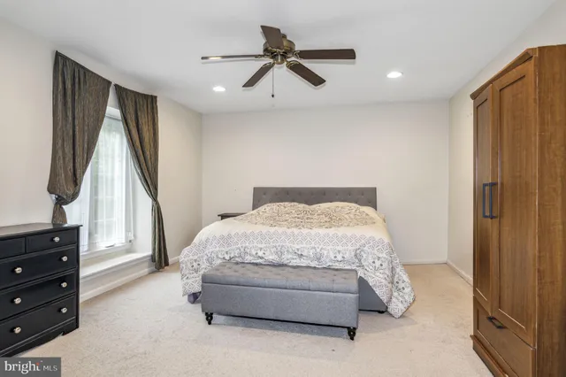 a spacious bedroom with a bed and a window