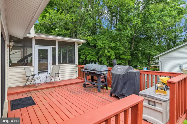 a view of a deck with table and chairs with wooden floor and fence