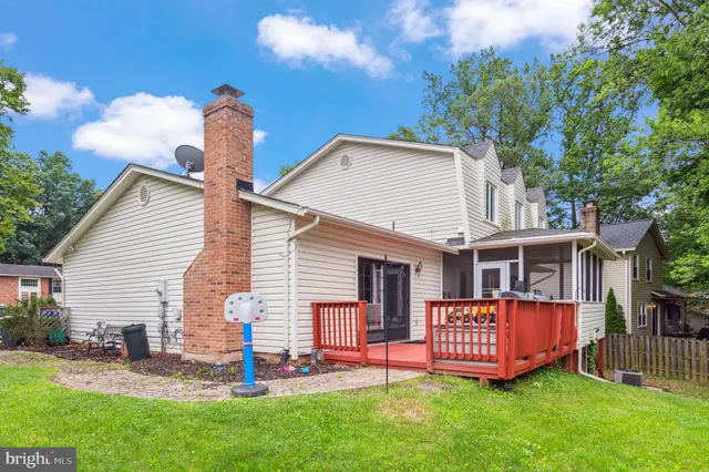 a view of a house with a yard and sitting area