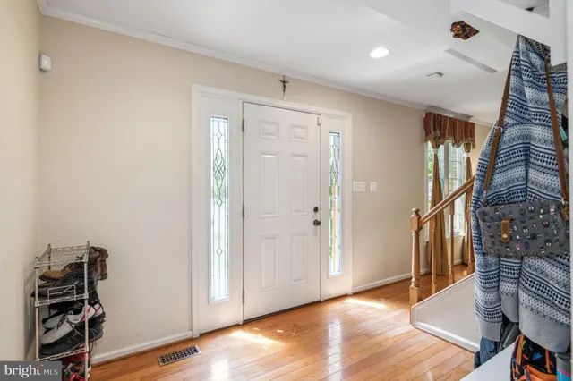 a view of an entryway with wooden floor
