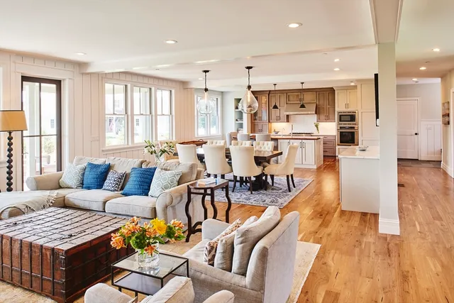 a living room with lots of furniture and wooden floor