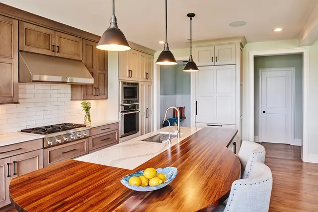 a kitchen with sink and wooden floor