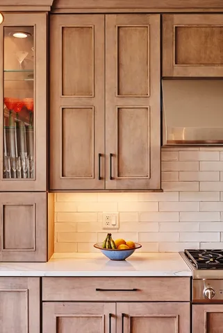 a kitchen with granite countertop cabinets and window