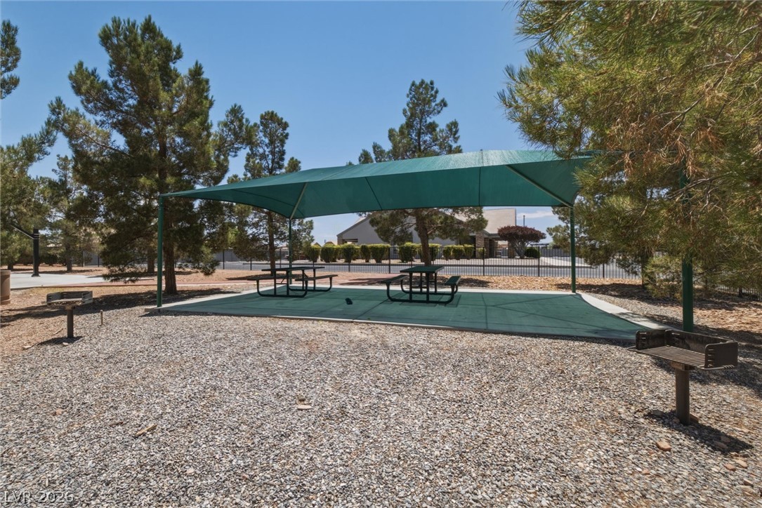 6720 Stubblefield Drive Pahrump, NV 89061 - Photo 44 of 51 An inviting outdoor area with shaded picnic tables, ideal for community gatherings and relaxation.