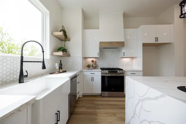 a kitchen with a sink cabinets and stainless steel appliances