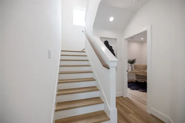 a view of entryway and hall with wooden floor
