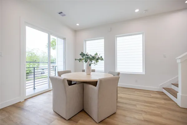 a dining room with furniture wooden floor and a potted plant