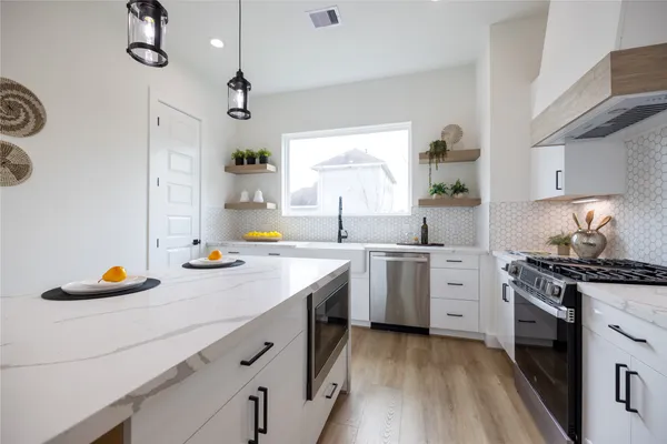 a kitchen with a sink stove and cabinets