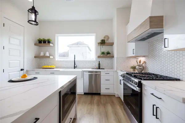 a kitchen with a stove a sink and a refrigerator