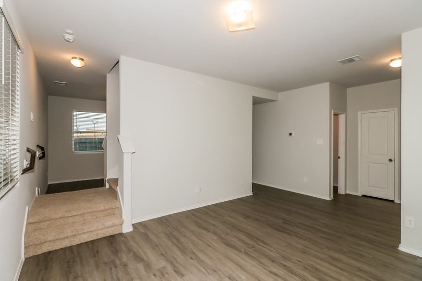 21626 Mamba Way Houston, TX 77073 - Photo 5 of 12 an empty room with wooden floor and windows
