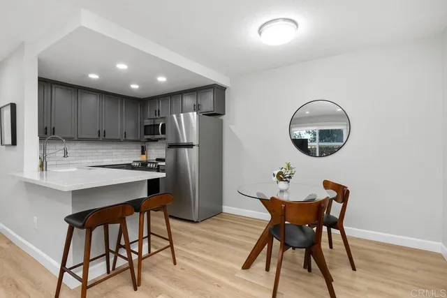 a kitchen with refrigerator and cabinets