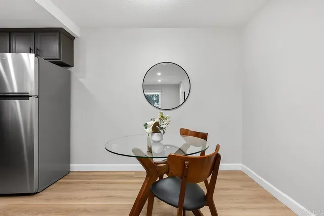 a dining room with furniture and wooden floor