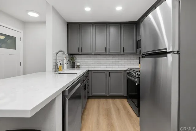 a kitchen with a sink appliances and cabinets