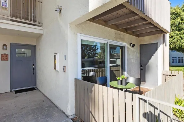 a view of a house with wooden fence