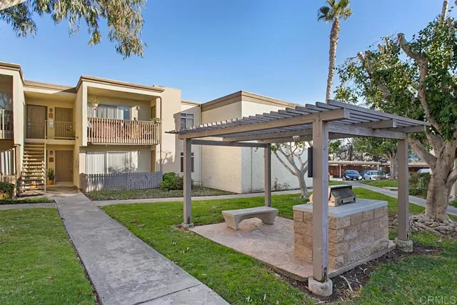 a backyard of a house with table and chairs