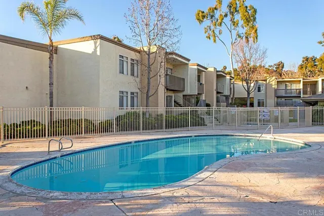 a view of a swimming pool with outdoor seating
