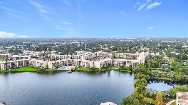 a view of a lake with boats and trees in the background