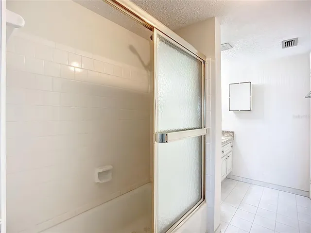 a bathroom with a shower and a glass door