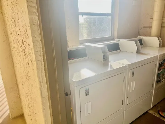 a view of a balcony with a couch and wooden floor