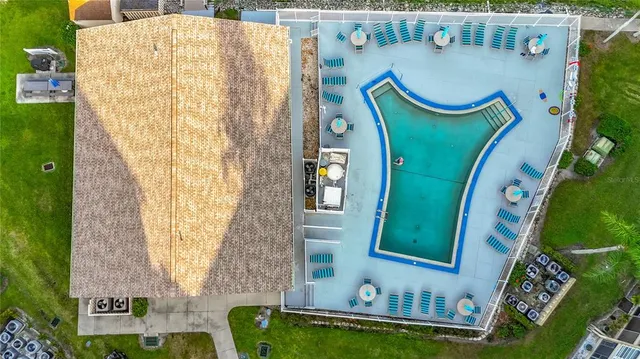 an aerial view of a fireplace with table and chairs