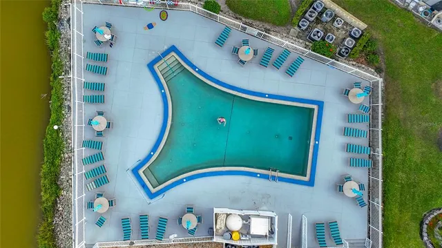 an aerial view of a residential house with yard and swimming pool