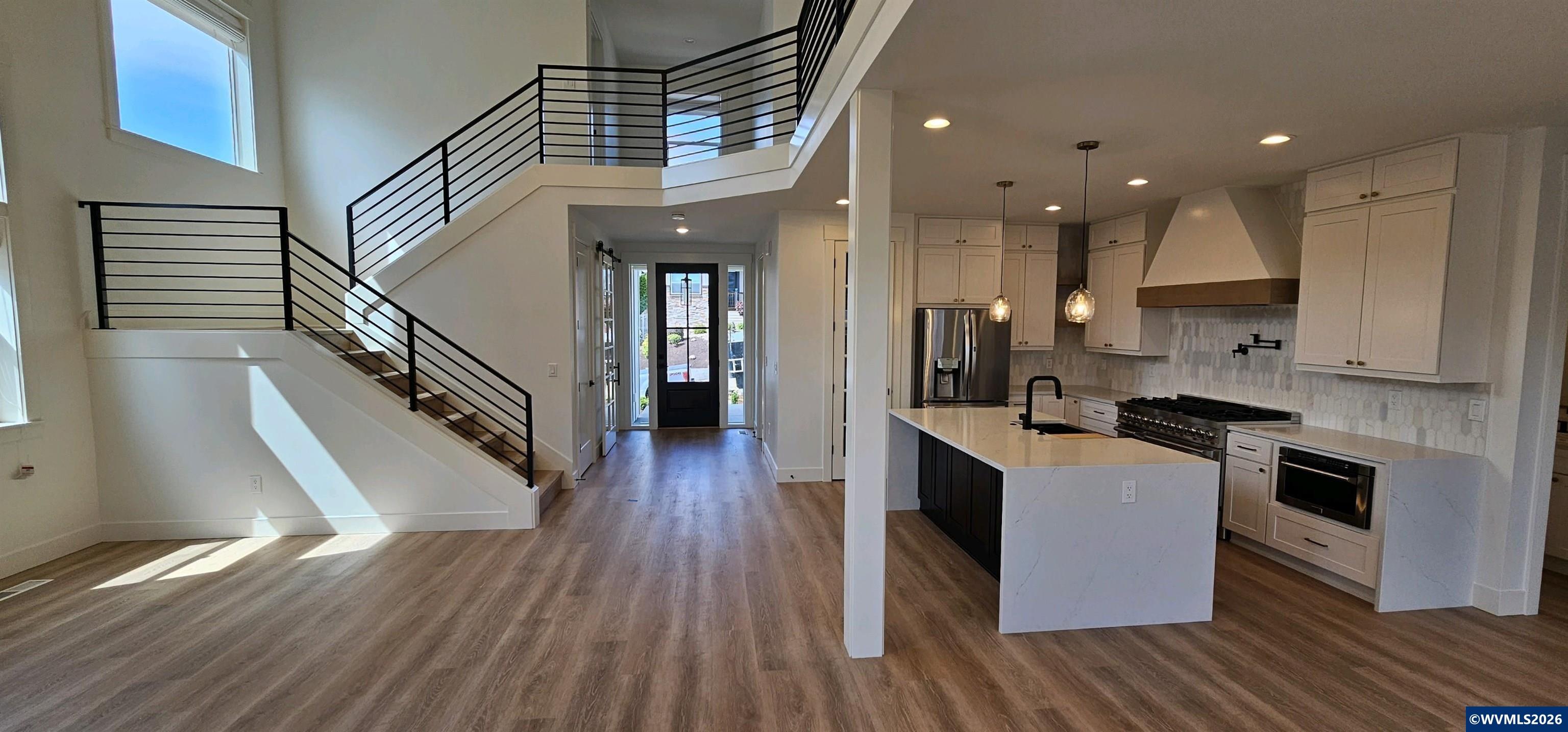 Model B Salishan Street Southeast Salem, OR 97302 - Photo 4 of 30 a kitchen with kitchen island wooden floors appliances and cabinets