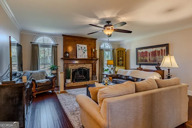 a living room with furniture a fireplace and a flat screen tv