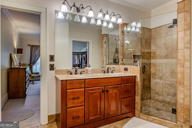 a bathroom with a double vanity sink mirror and shower