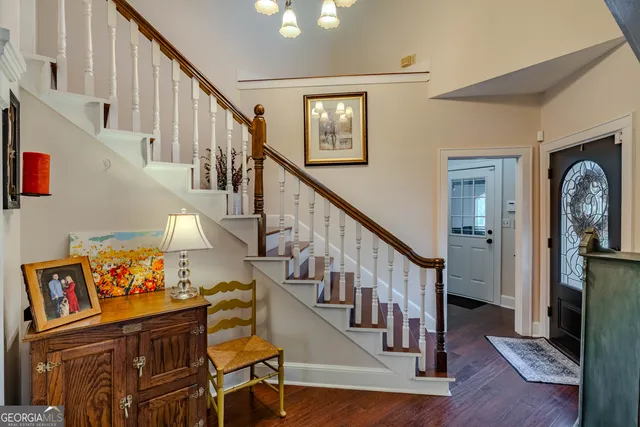 a view of entryway with wooden floor and stairs