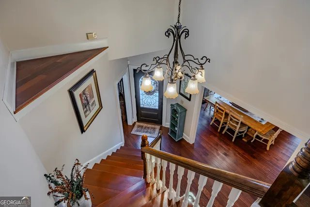 a view of a livingroom with furniture staircase and hallway