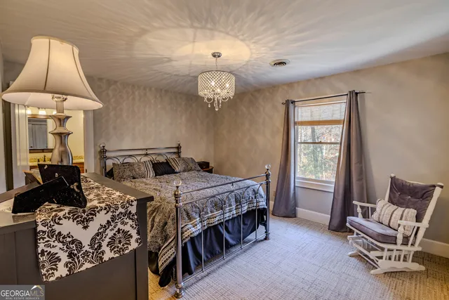 a bed room with a bed and a chair