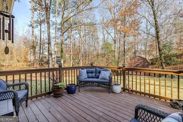 a view of a roof deck with wooden floor and fence
