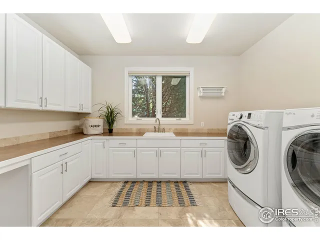 a living room with a bed furniture and a large window