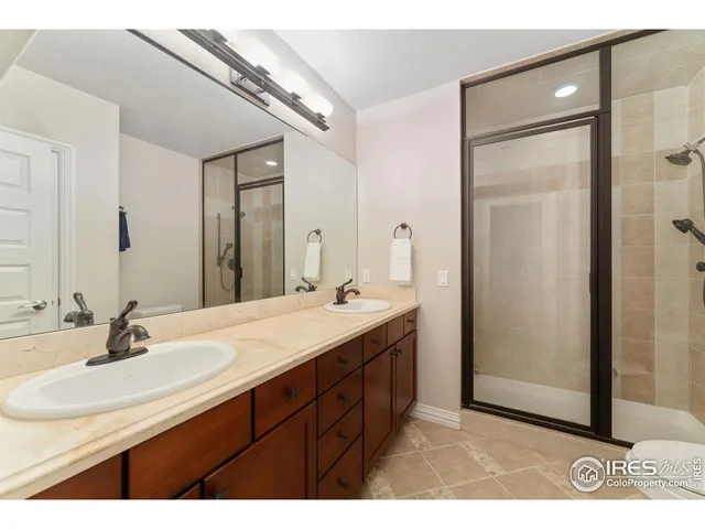 an empty room with wooden floor and ceiling fan
