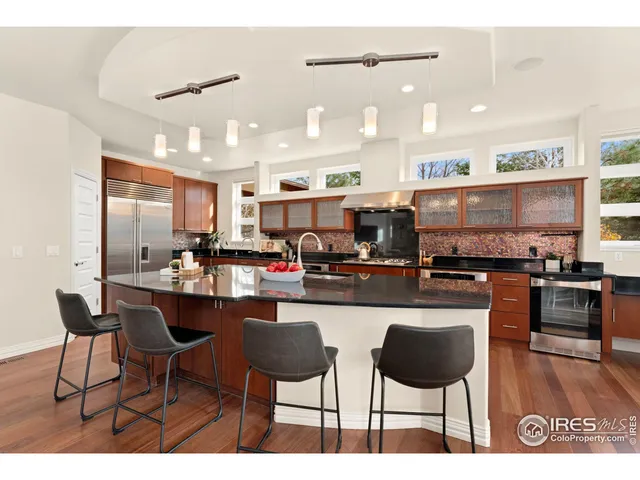 a living room with lots of furniture and kitchen view