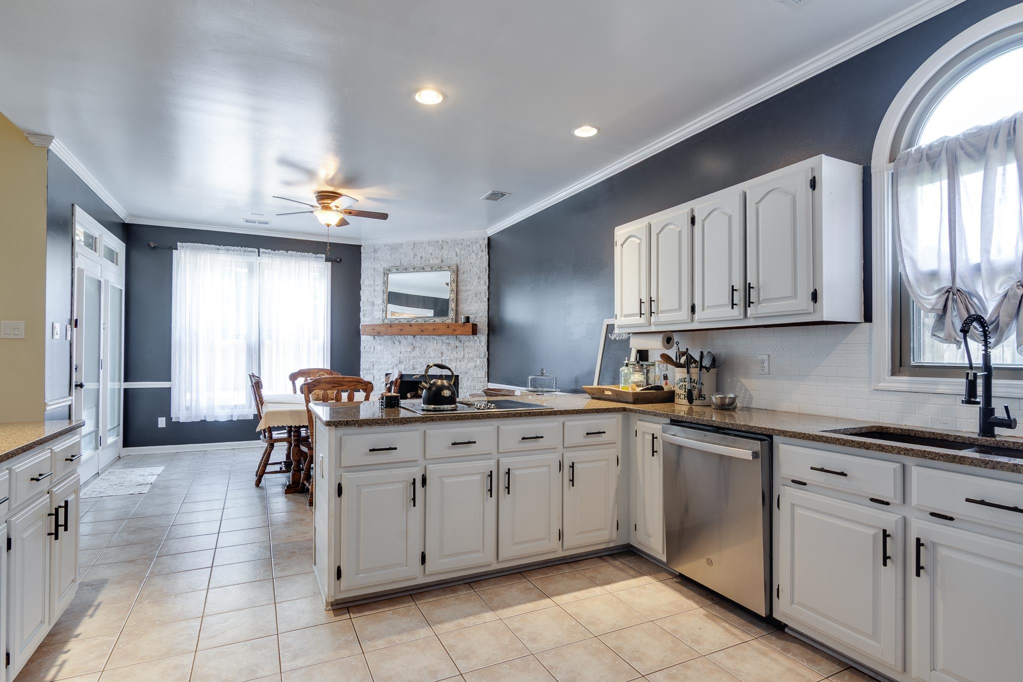 779 Early Earner Cove Collierville, TN 38017 - Photo 11 of 29 Kitchen with white cabinetry, granite countertops, and stainless steel appliances