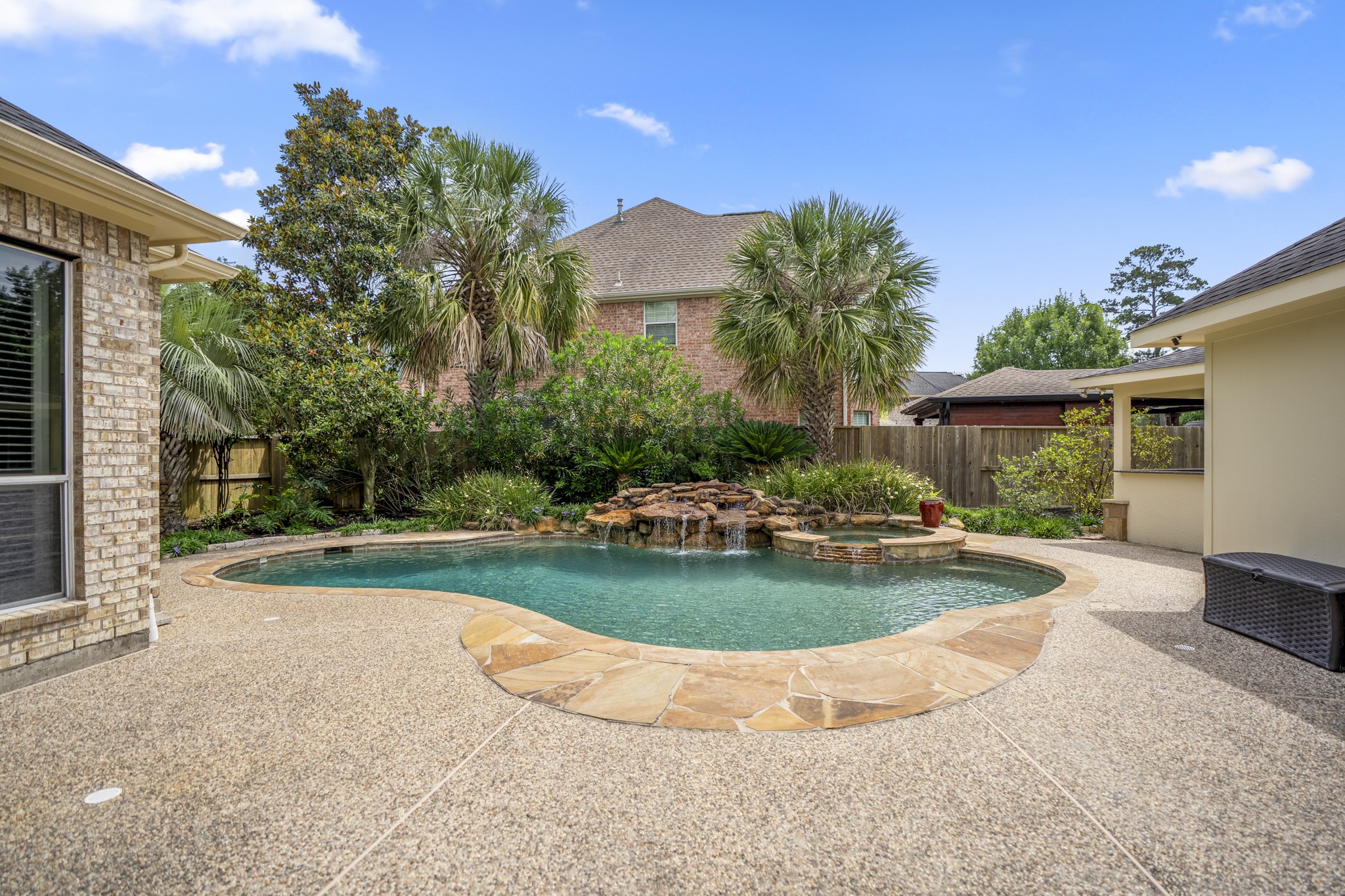 1438 Hatchmere Place Spring, TX 77379 - Photo 34 of 50 Enjoy summertime with the sparkling pool with rock waterfall and raised spa surrounded by beautiful landscaping.