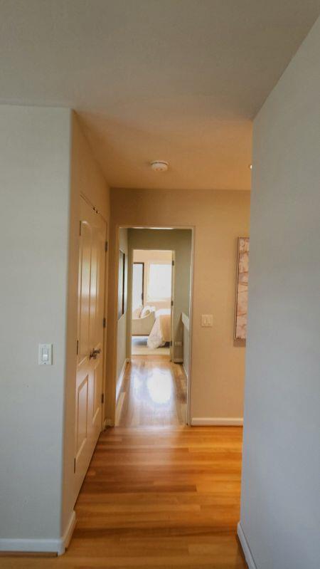 3850 Rio Road, Unit 57 Carmel, CA 93923 - Photo 14 of 25 a view of a hallway view with wooden floor and a living room