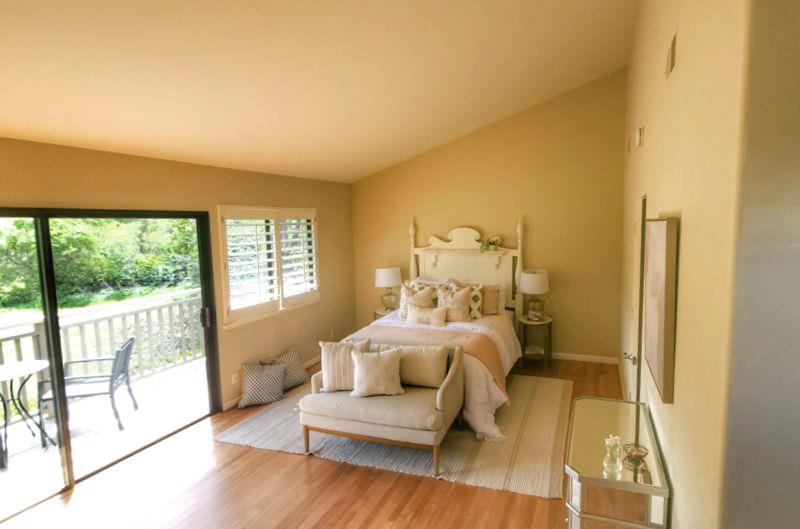 3850 Rio Road, Unit 57 Carmel, CA 93923 - Photo 15 of 25 a bedroom with a bed and wooden floor