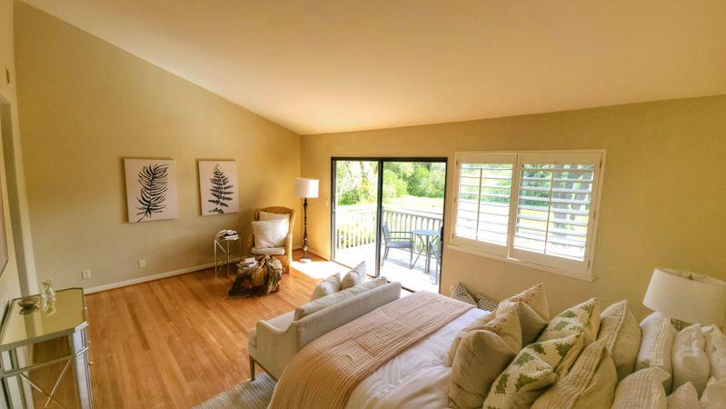 3850 Rio Road, Unit 57 Carmel, CA 93923 - Photo 16 of 25 a bed sitting in a bedroom next to a window