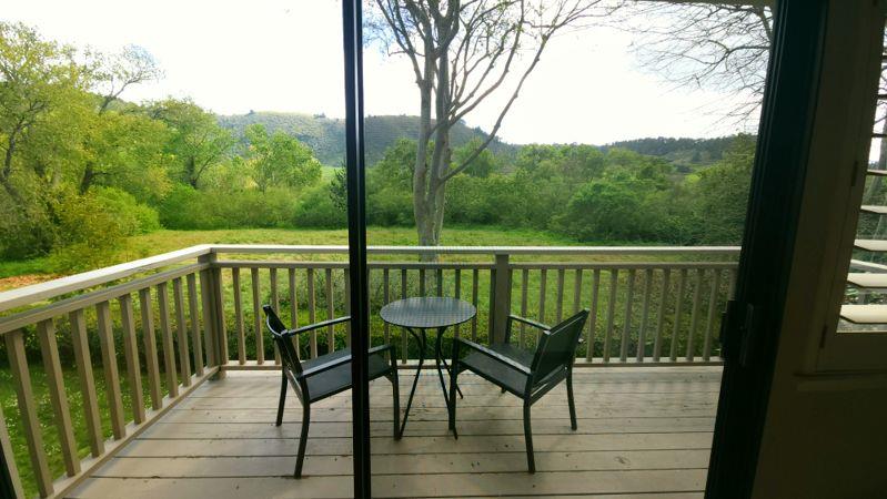 3850 Rio Road, Unit 57 Carmel, CA 93923 - Photo 20 of 25 a view of a balcony with chairs and wooden floor