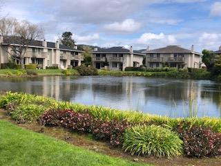 3850 Rio Road, Unit 57 Carmel, CA 93923 - Photo 24 of 25 a view of a lake with a house in the background
