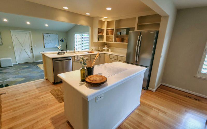 3850 Rio Road, Unit 57 Carmel, CA 93923 - Photo 5 of 25 a kitchen with stainless steel appliances granite countertop a sink and a refrigerator