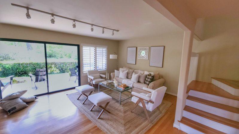 3850 Rio Road, Unit 57 Carmel, CA 93923 - Photo 8 of 25 a living room with furniture large windows and wooden floor